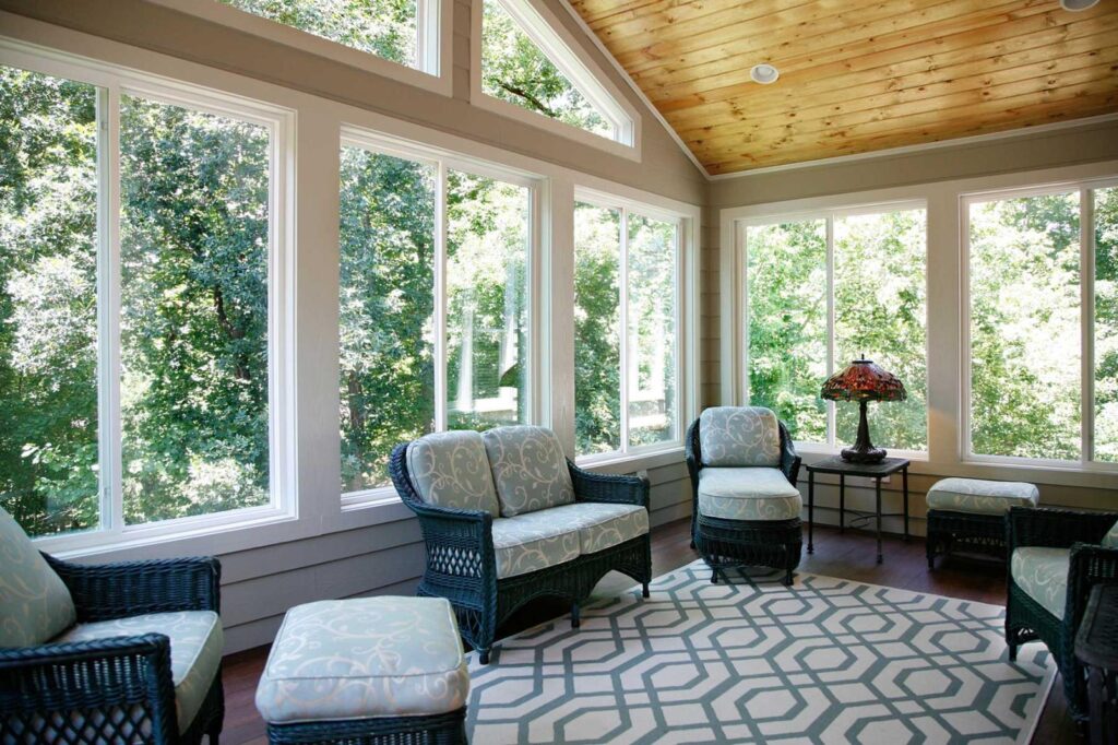 Sunroom with large vinyl windows and natural light showcasing residential window installation