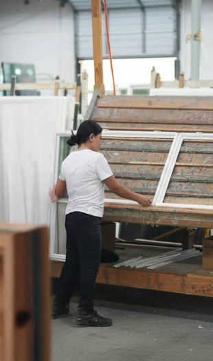 Contractor installing custom vinyl replacement window for Atlanta project