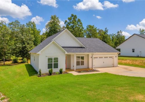Single-story new construction home with vinyl windows and attached garage showcasing residential window installation