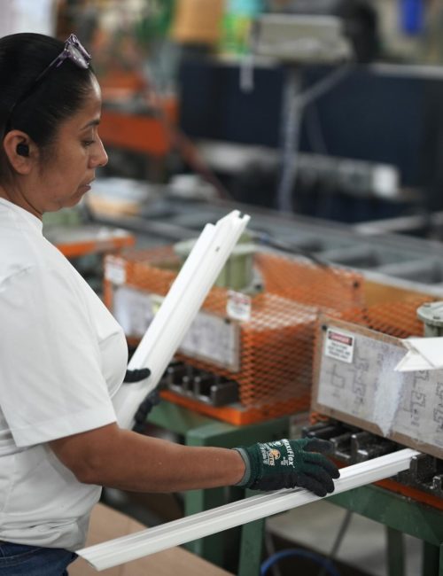 Windowcrafters employee assembling vinyl window frames on production line in Tucker Georgia factory