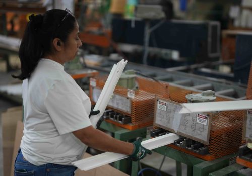 Windowcrafters employee assembling vinyl window frames on production line in Tucker Georgia factory